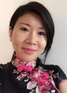  Jie Zheng wearing a black shirt and pink floral neckless